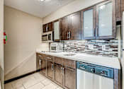 Thumbnail 15 of 17 - A kitchen with a stainless steel refrigerator, microwave, and dishwasher.