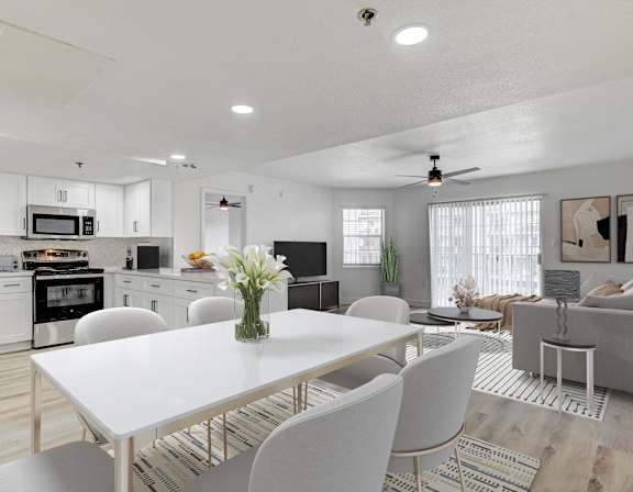 A modern kitchen with a dining table and chairs.