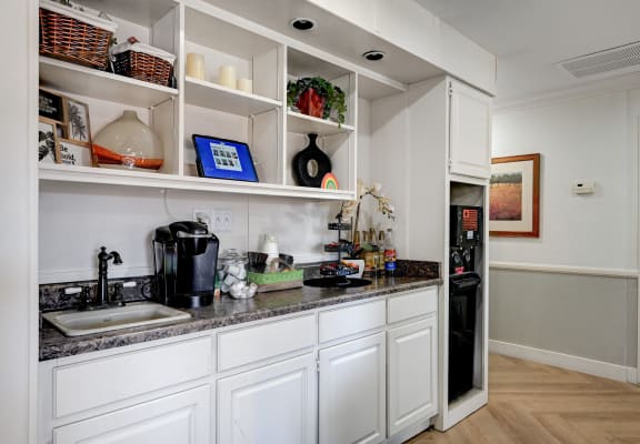 a kitchen with white cabinets and a sink and a refrigerator at Desert Bay Apartments, Laughlin,89029