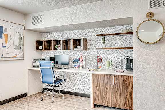 A room with a desk and a chair.