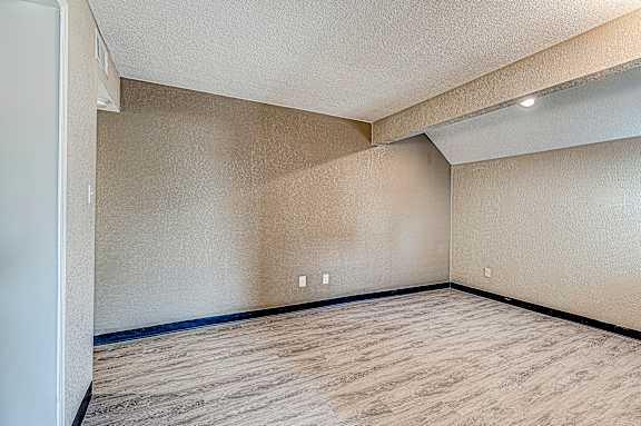 Empty room with light brown walls and floor.
