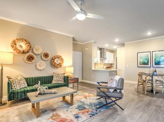 a living room with a couch and chairs and a dining room table