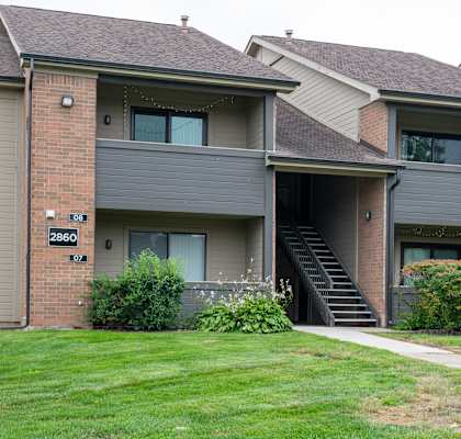 Apartment building with green lawn in front at Pine Ridge Apartments, Rochester Hills