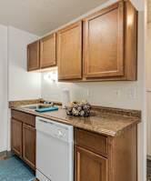 a kitchen with wood cabinets and a black stove top oven