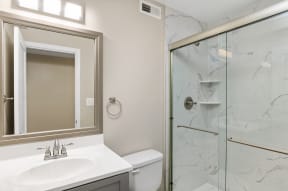 a bathroom with a toilet sink and shower