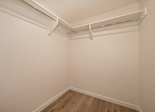 a small room with white walls and a wooden floor at Croft Plaza Apartments, West Hollywood, CA