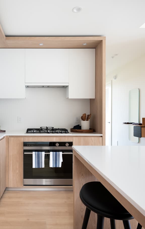 A modern kitchen with wooden cabinets and stainless steel appliances.