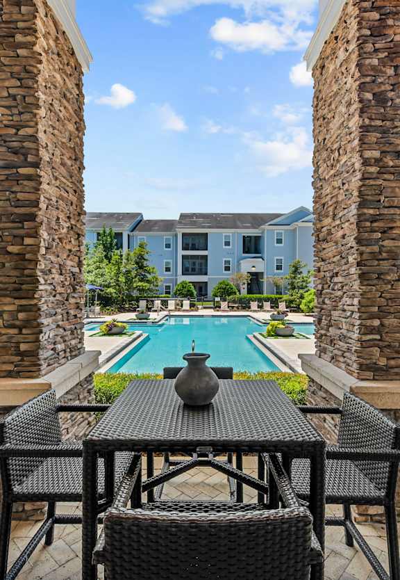 a resort style pool with hammocks and lounge chairs at Village at Terra Bella Apartments, Land O' Lakes, Florida