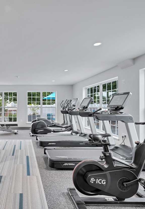 a gym with treadmills and other exercise equipment