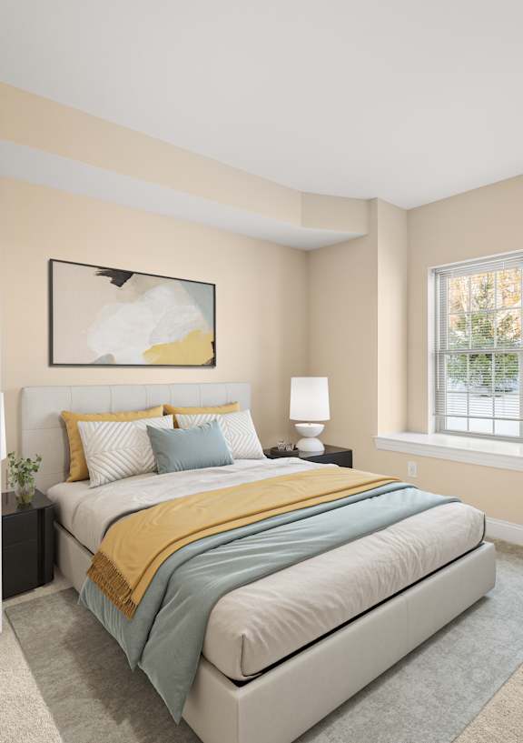 A bedroom with a bed, nightstand, and window.