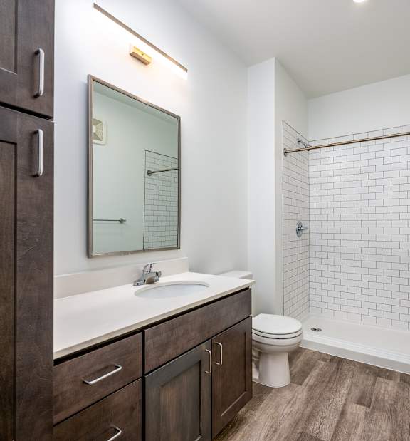 A bathroom with a white sink and a white toilet.