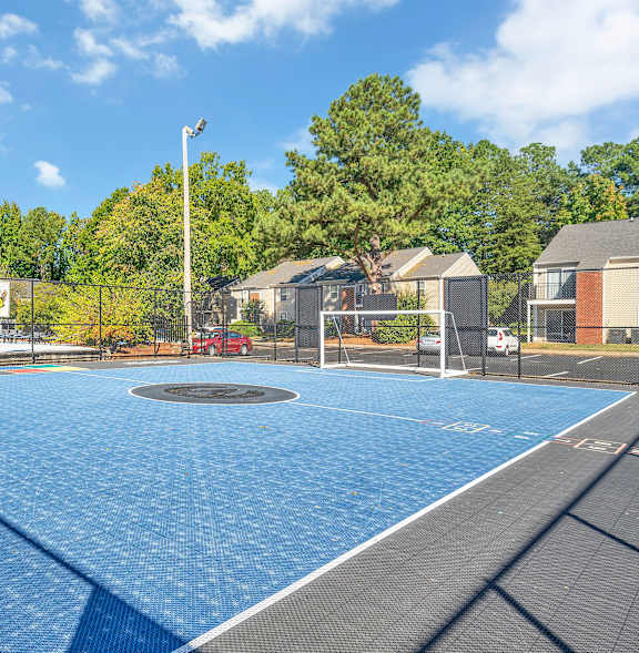 A playground with a slide and a tree in the background.
