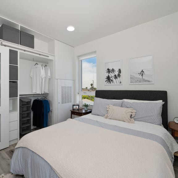 a bedroom with a large bed and a closet