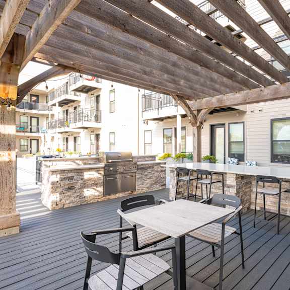 A wooden deck with a table and chairs.
