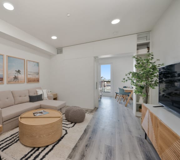 a living room with a gray couch and a white table
