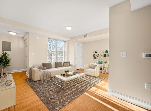 A living room with a white couch and a coffee table.