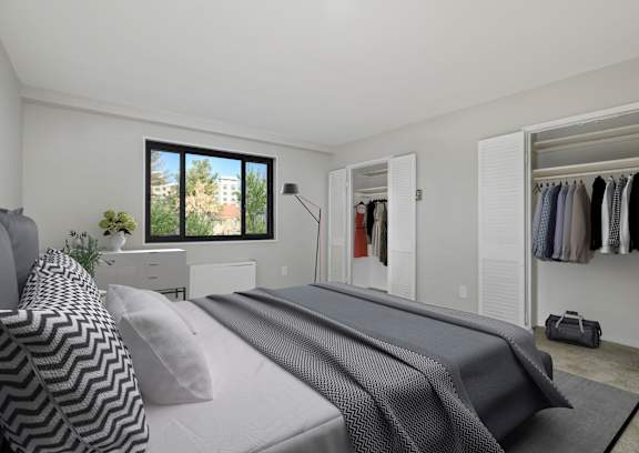 A bedroom with a large bed and a wardrobe at Earle Manor Apartments, Wheaton, MD 20902