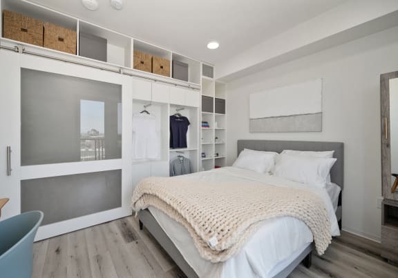a bedroom with a bed and a white closet