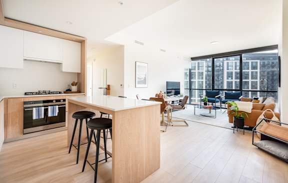A modern kitchen with a bar stool and a countertop.