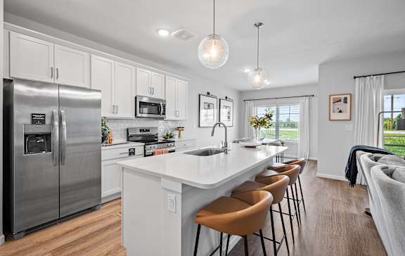 a view of a kitchen with a island and blue chairs