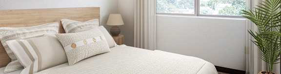 a bedroom with a bed and a large window