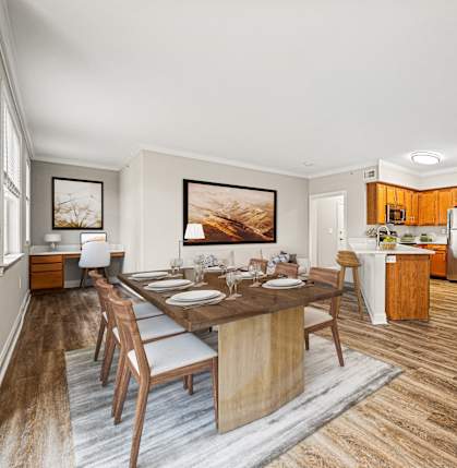 A modern dining room with a wooden table and chairs.