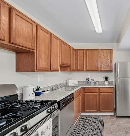 a kitchen with wooden cabinets and stainless steel appliances