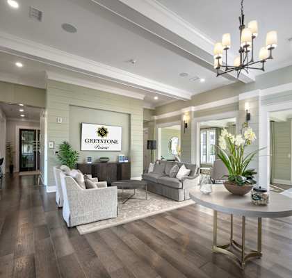 A living room with a sign that says "Greystone Village".