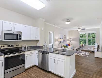 a kitchen with white cabinets and stainless steel appliances