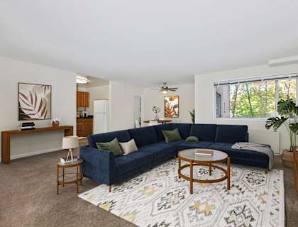 a living room with a blue couch and a rug