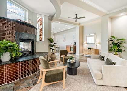 A living room with a fireplace and a couch. at River House Apartments, Norfolk, Virginia