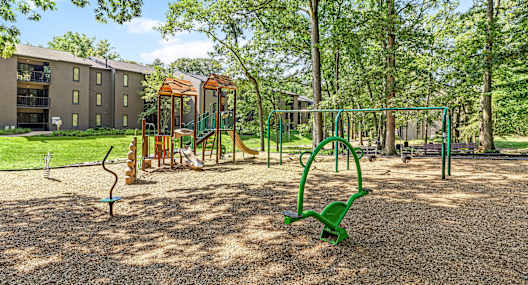 A park with picnic tables and trees.