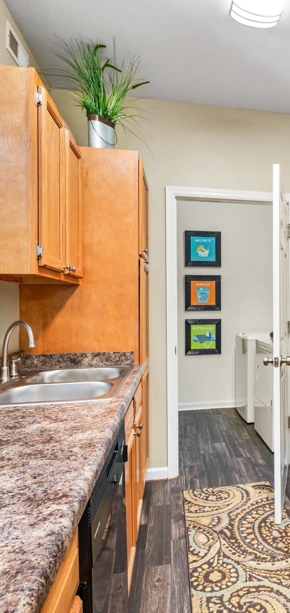 a kitchen with granite counter tops and black appliances