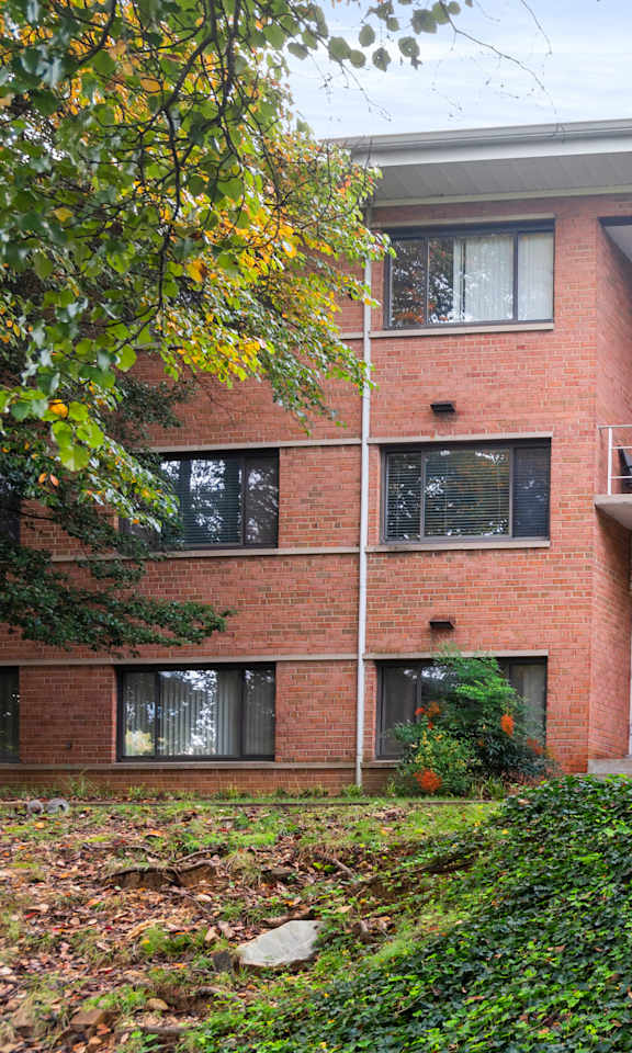 A red brick building with a white door and windows.