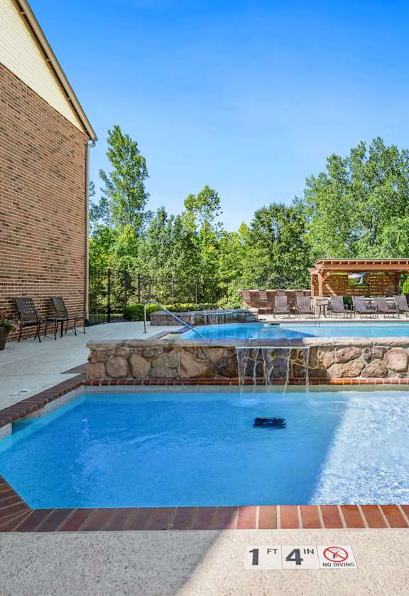 our resort style swimming pool is next to our house with a spa and a patio