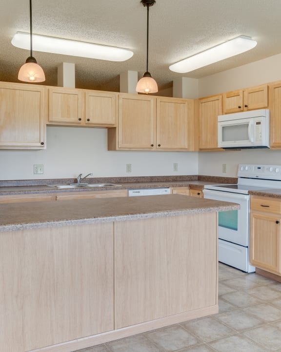 a kitchen with white appliances and brown walls