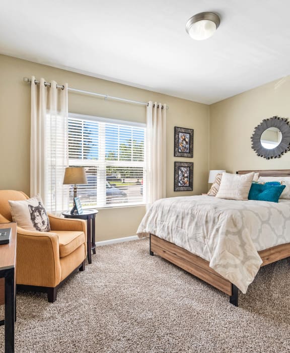 a bedroom with a large bed and a window