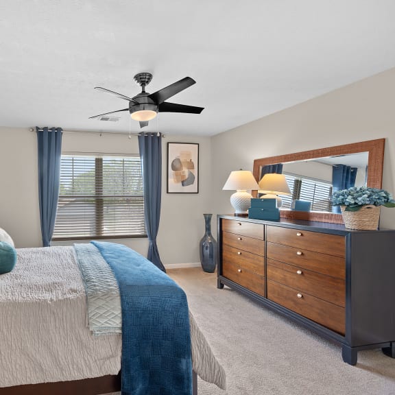 Bedroom with a large bed and a ceiling fanat Four Bridges, Liberty Township