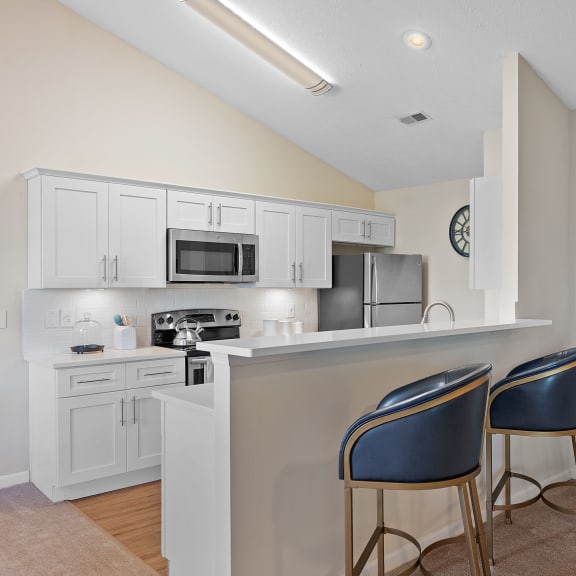 Kitchen with a bar with two chairs and a sink at Four Bridgesat Four Bridges, Liberty Township