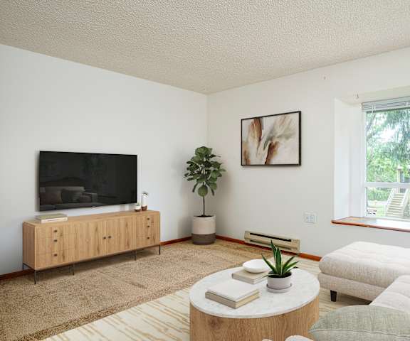 A living room with a flat screen TV and a couch.