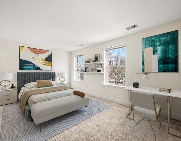 A bedroom with a bed, a desk, and a painting on the wall.