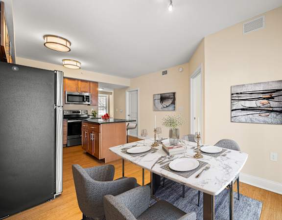 A dining room with a table set for two.