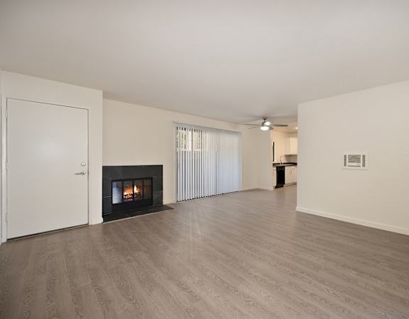 a living room with a fireplace and white walls