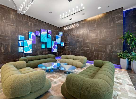 A modern room with a large screen and comfortable seating.
