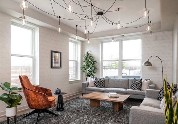 a living room with couches and chairs and a table
