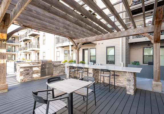 A wooden deck with a table and chairs.