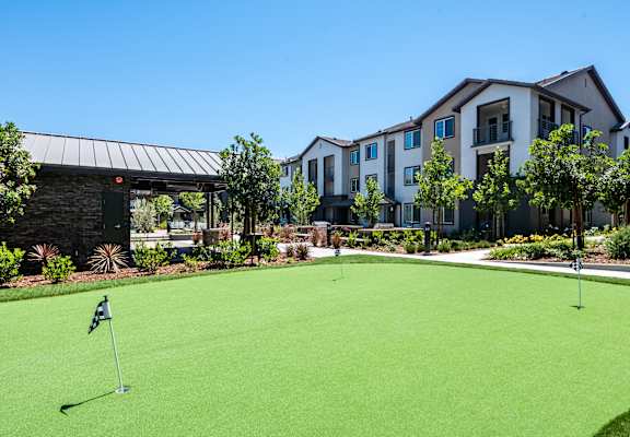 a putting green in front of a building at The Vineyards Apartments, California, 91326