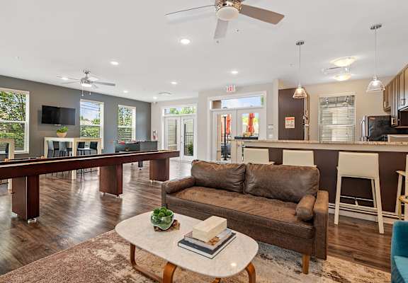 a living room and kitchen with a couch and a table at DeSales Flats Apartments*, Cincinnati, 45206