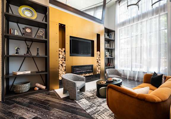 a living room with a couch and a chair and a fireplace
