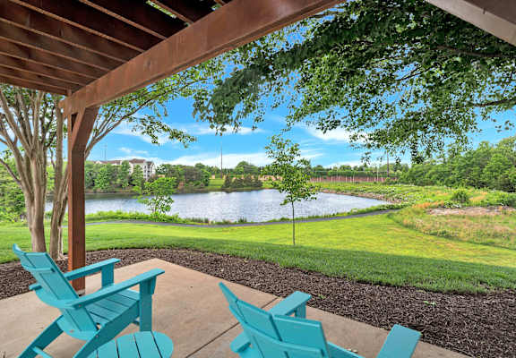 A view of a lake from a covered patio.